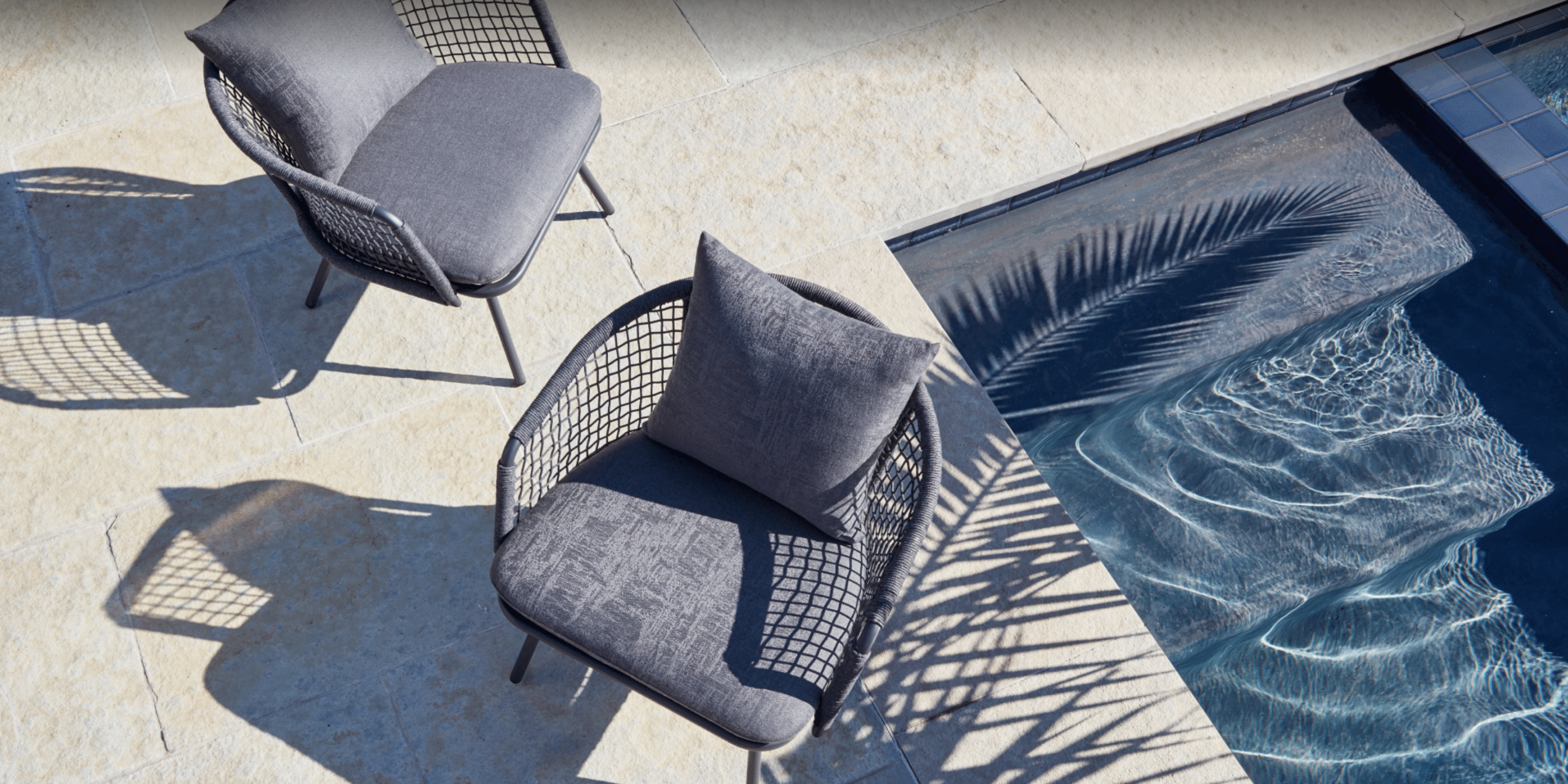 Ventana lounge chairs by Terra Outdoor positioned next to pool