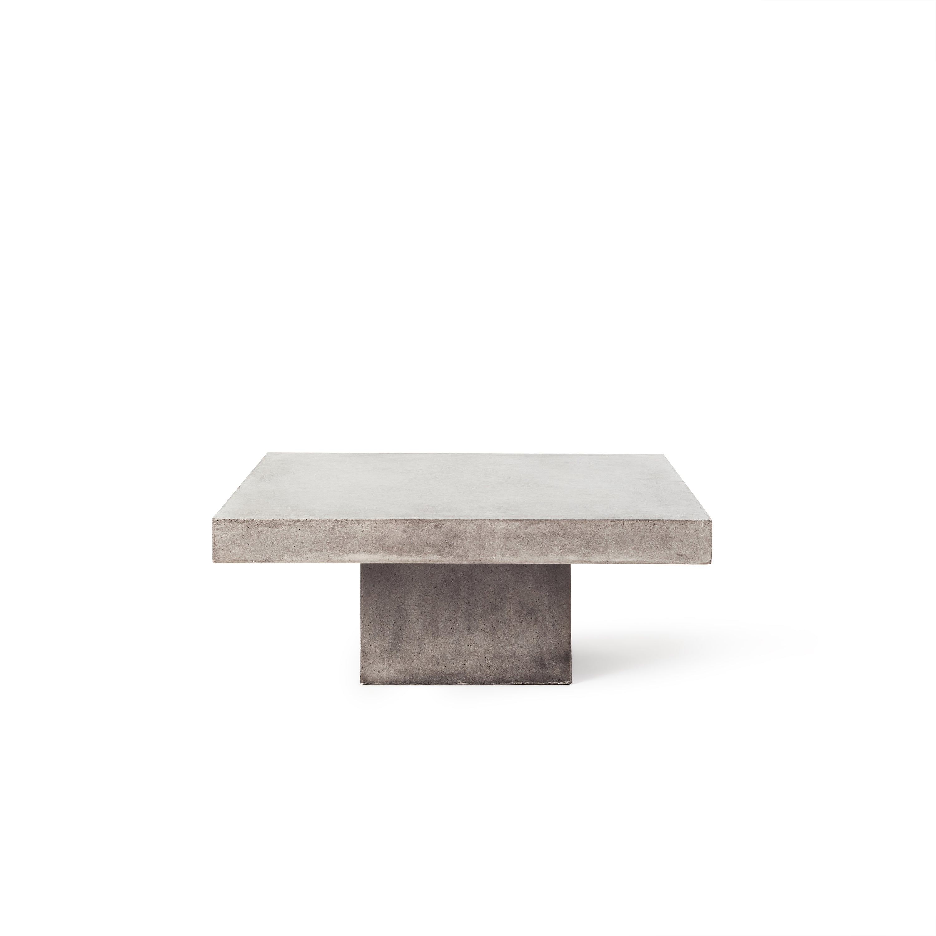 Mason Floating Square Coffee Table by Terra Outdoor Living is made entirely from Glass Fiber Reinforced Concrete, and its surface effect resembles that of industrial concrete. It features a square pedestal base, and a square slab of GFRC forms the top.