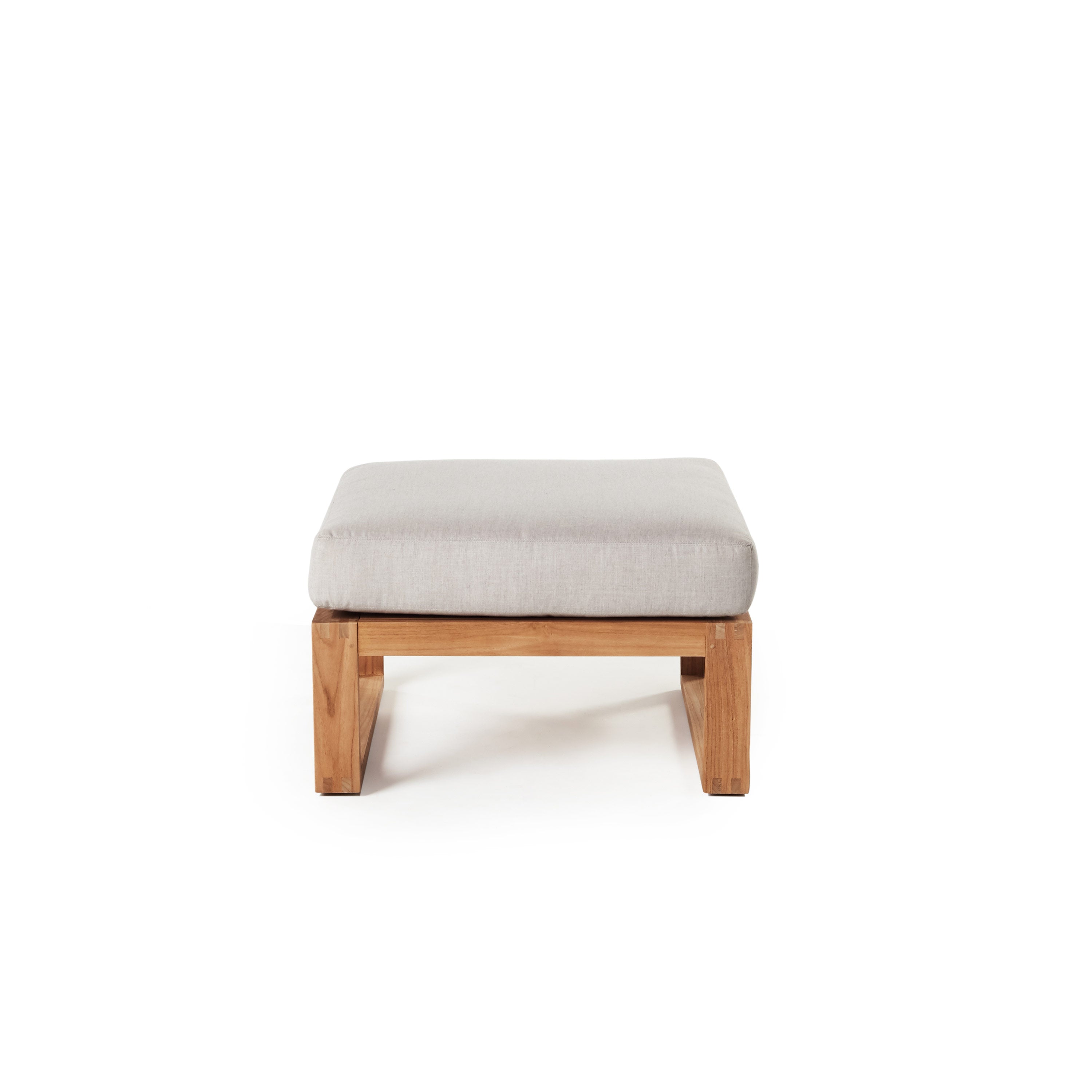 Belvedere Ottoman in Teak by Terra Outdoor Living features a low-profile premium teak frame paired with a thick weather-friendly cushion in Cast Silver—ideal as a footrest or extra seat and designed to pair seamlessly with other Belvedere seating components.