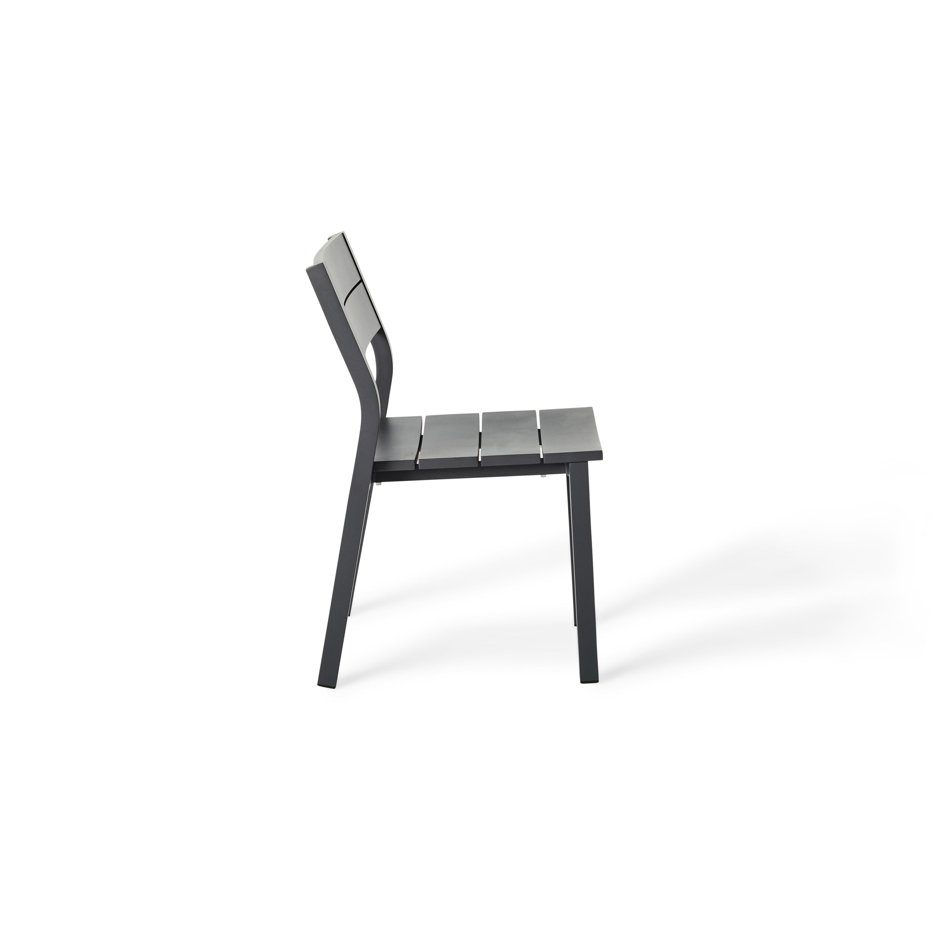 Belvedere Dining Side Chair in Charcoal by Terra Outdoor Living combines expertly crafted aluminum and durable finishes with a slightly scooped seat and flared back for enhanced comfort, plus a stackable design for easy, compact storage.