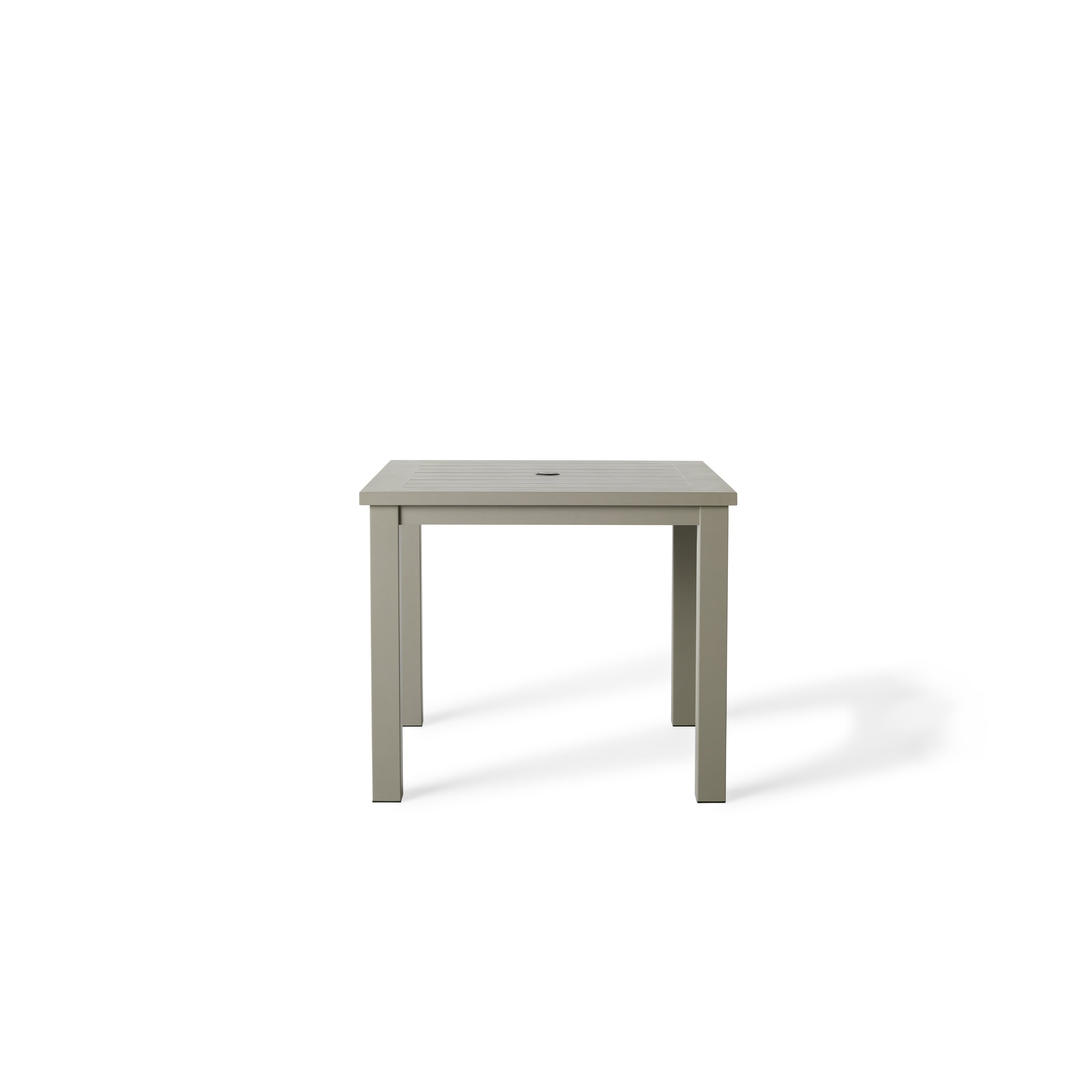 Belvedere Square Dining Table by Terra Outdoor Living in Quartz Grey, a warm grey tone, shown with a slatted aluminum top and central umbrella hole, featuring a clean-lined, modern silhouette in a compact size for versatile outdoor placement.