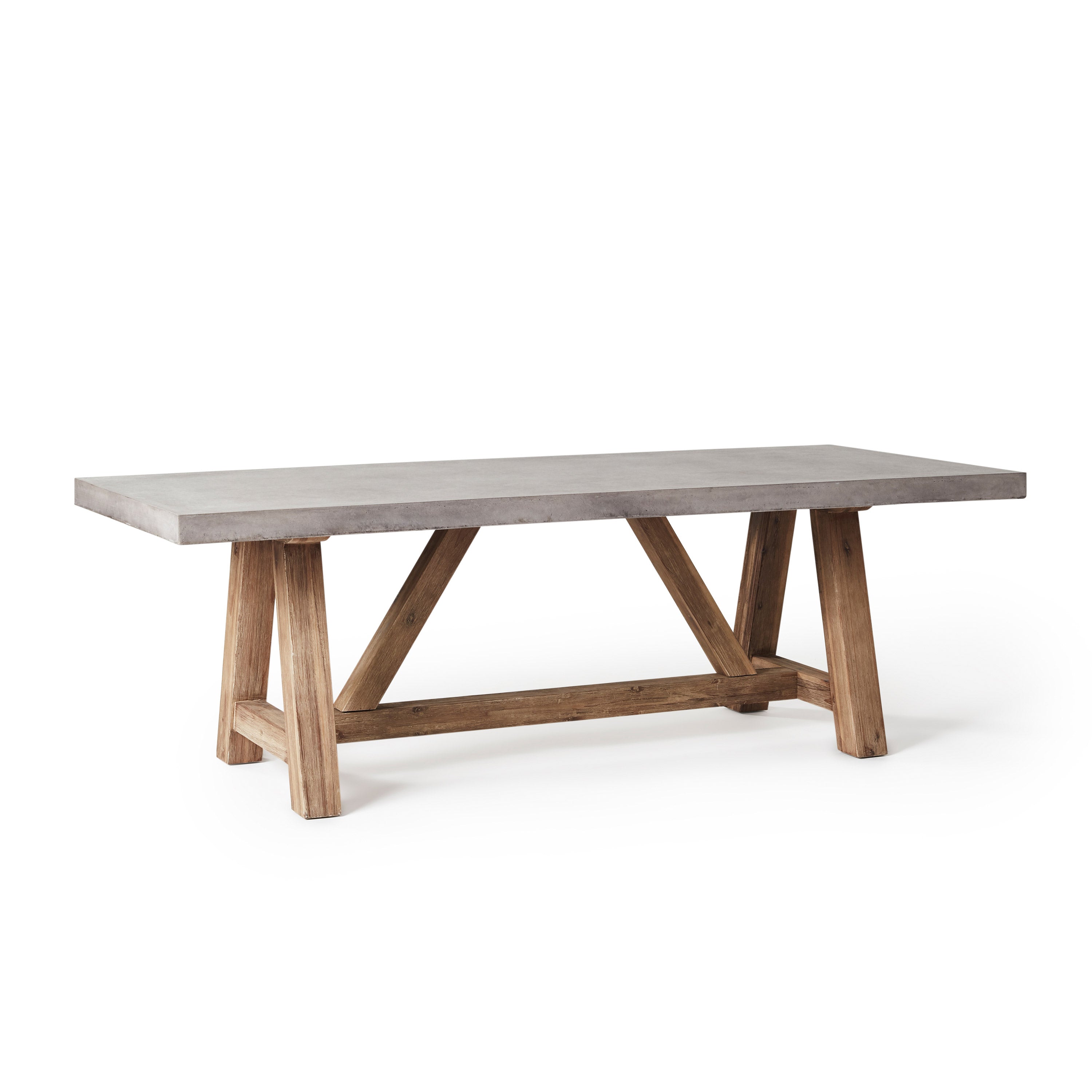 The Bordeaux 94" Dining Table by Terra Outdoor Living pairs a rustic acacia wood base inspired by antique trestle tables with a top crafted from a composite that delivers superior weather-resistance and durability with all the industrial appeal of concrete.
