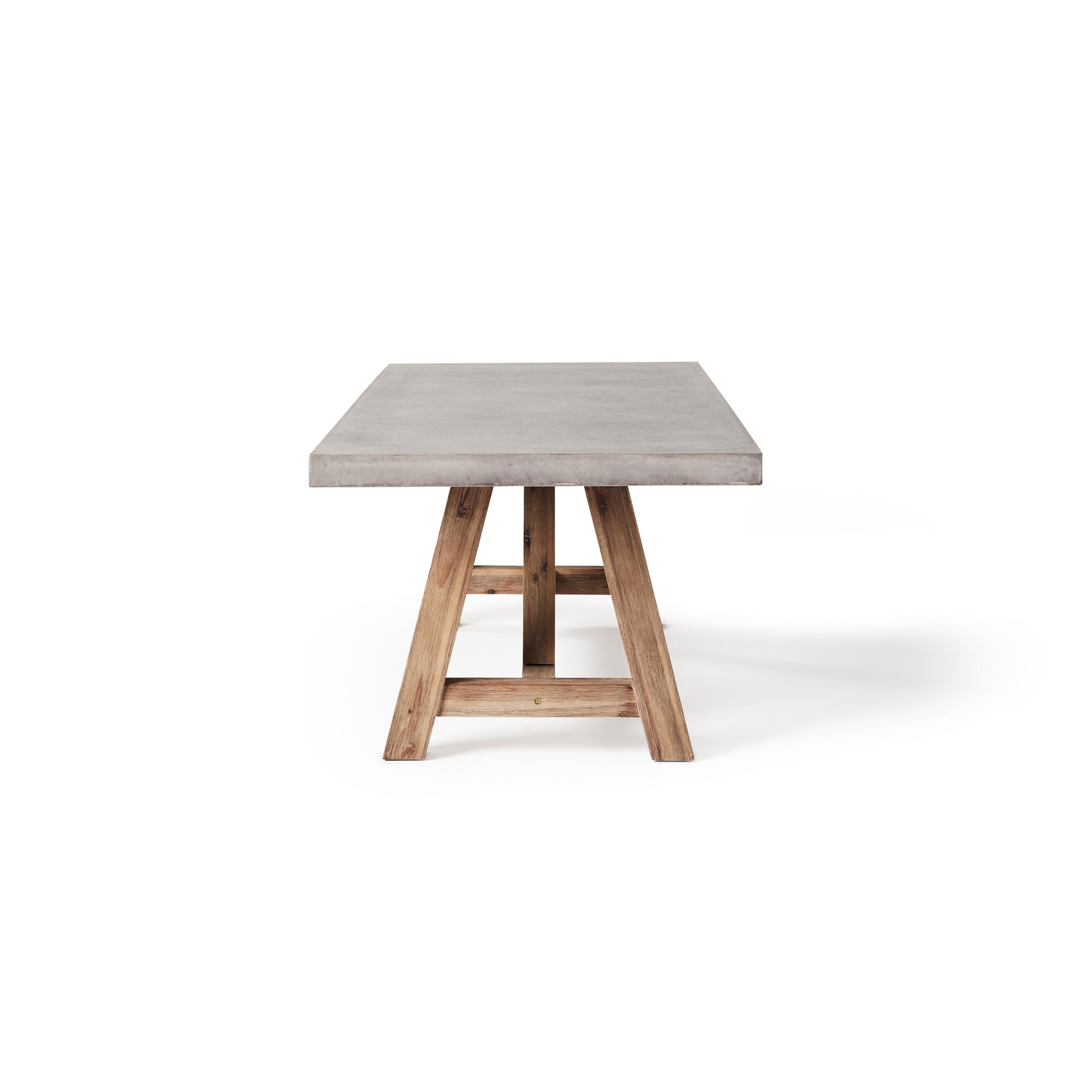 The Bordeaux 94" Dining Table by Terra Outdoor Living pairs a rustic acacia wood base inspired by antique trestle tables with a top crafted from a composite that delivers superior weather-resistance and durability with all the industrial appeal of concrete.