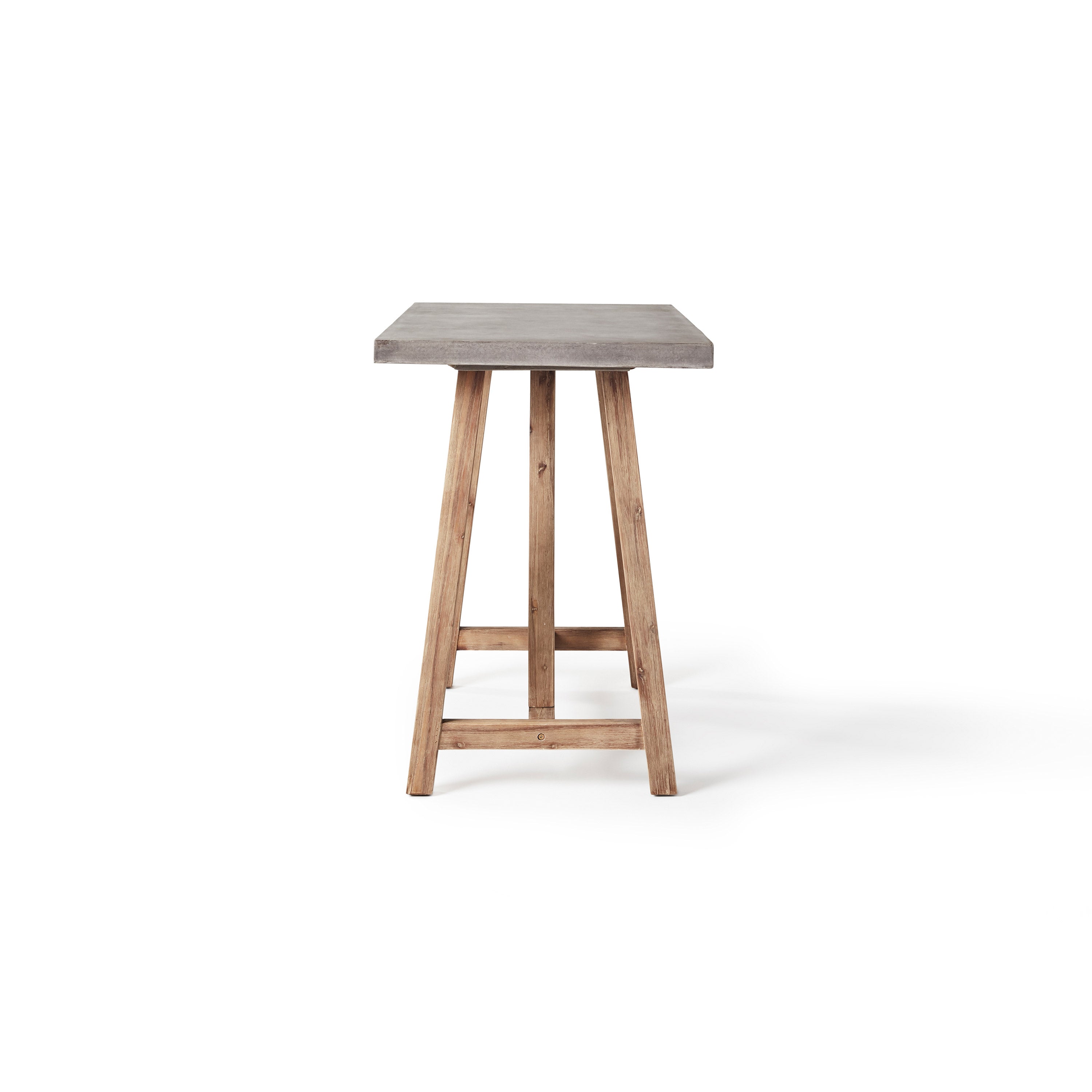 The Bordeaux Bar Table by Terra Outdoor Living pairs rustic acacia wood bases inspired by antique trestle tables with tops crafted from a composite that delivers superior weather-resistance and durability with all the industrial appeal of concrete (GFRC)