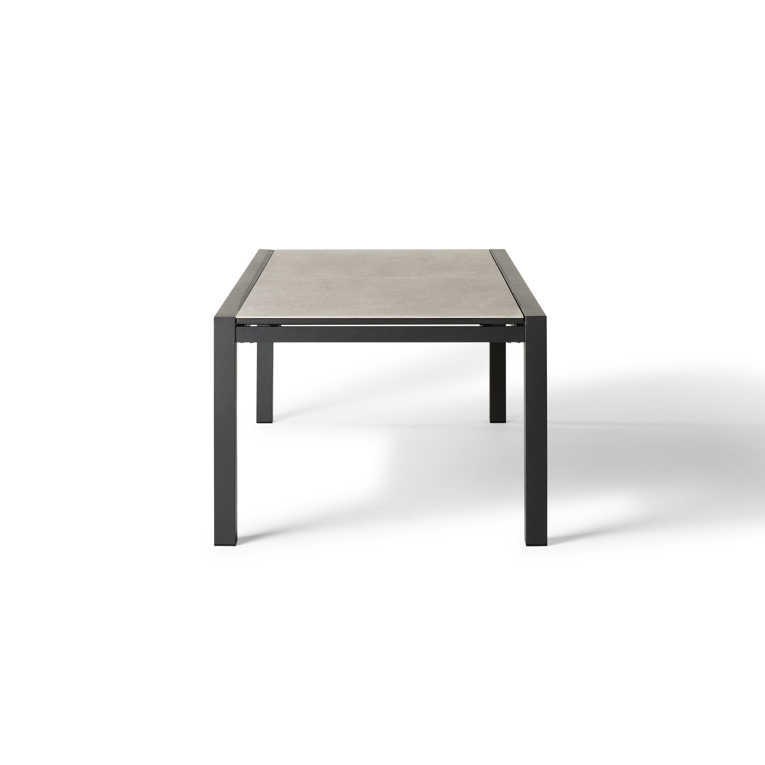 Del Mar Dining Table by Terra Outdoor Living — features an aluminum frame in 'Charcoal' with a ceramic top; seats up to 12 comfortably and includes a convenient extendable leaf that nests under the table when not in use, perfect for dining and entertaining.