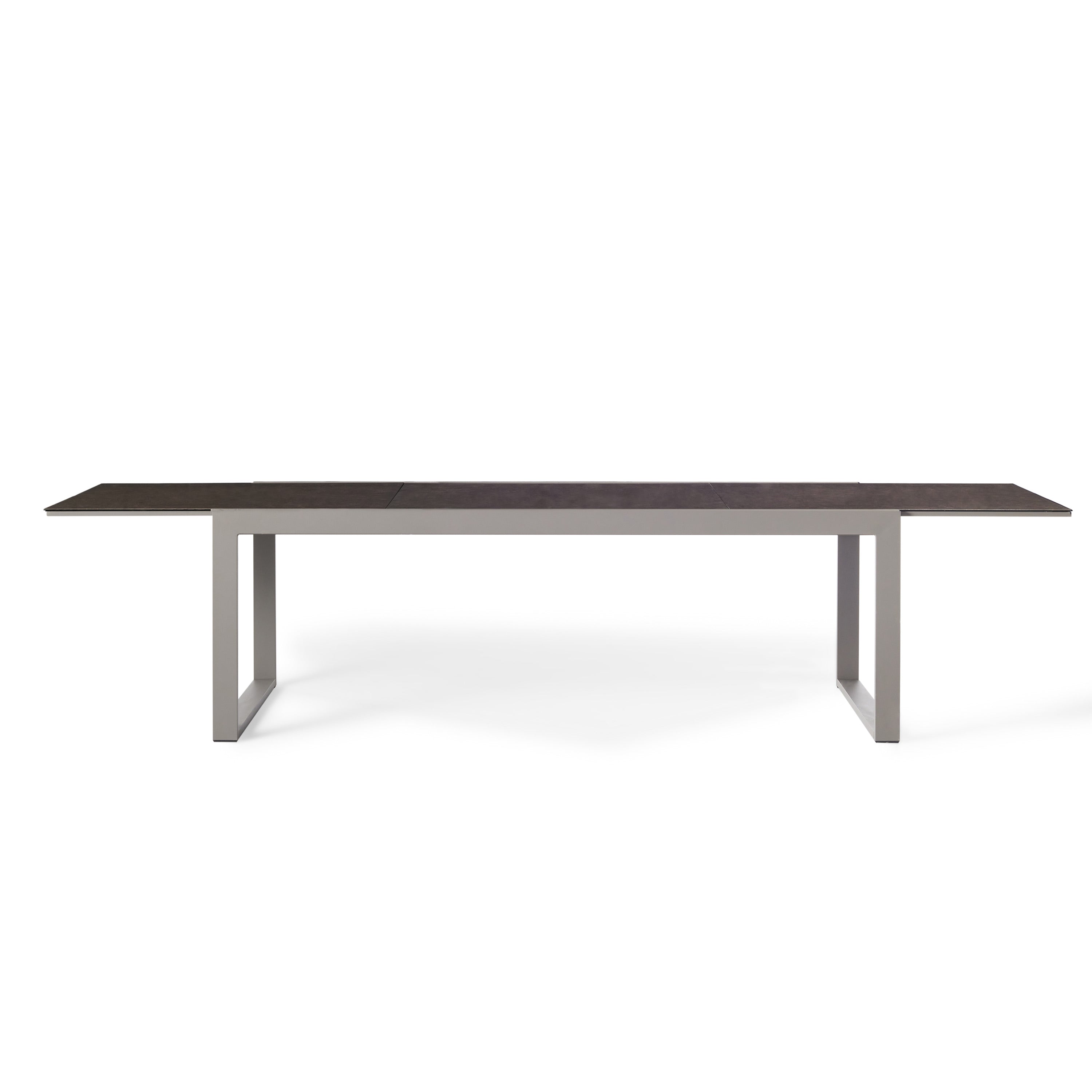 Diablo 87"-130" Extension Dining Table in Quartz Grey by Terra Outdoor Living is an extension dining table, with sled-style powdercoated aluminum frame and 'ceramic' coated tempered safety glass as the table top. It has a sleek modern look and can extend to suit the moment. Image shows table fully-extended.
