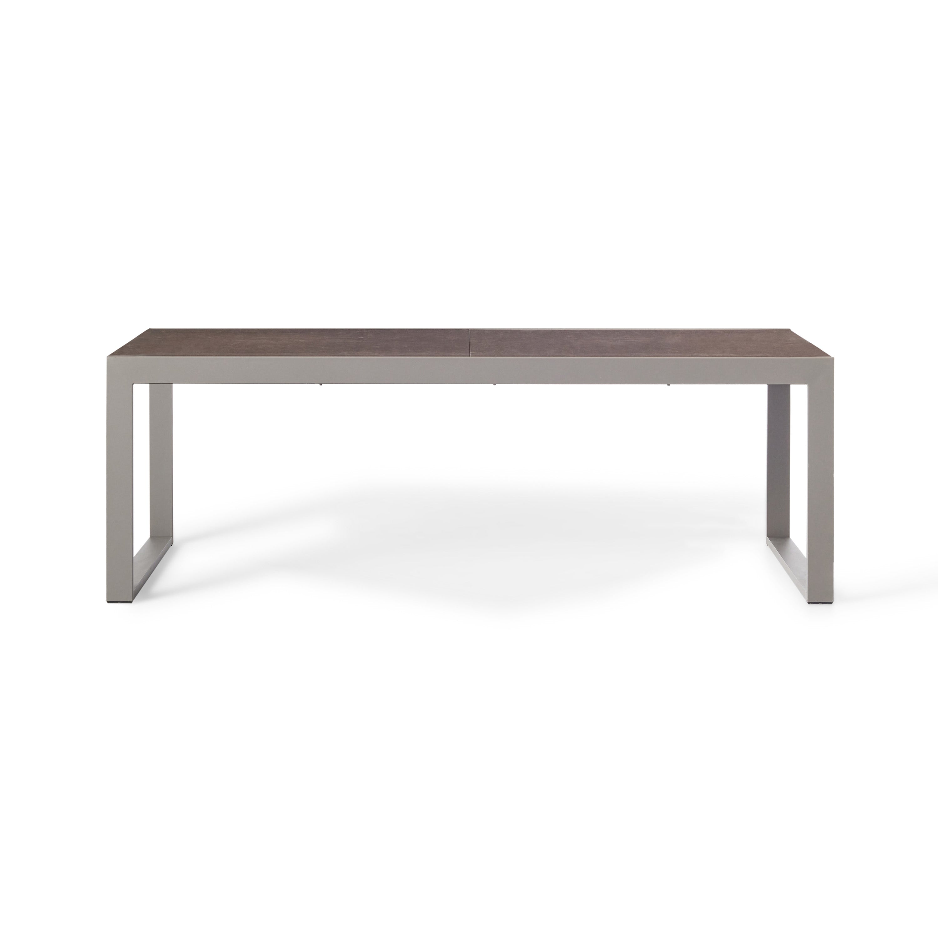 Diablo 87"-130" Extension Dining Table in Quartz Grey by Terra Outdoor Living is an extension dining table, with sled-style powdercoated aluminum frame and 'ceramic' coated tempered safety glass as the table top. It has a sleek modern look and can extend to suit the moment. Image shows table un-extended.