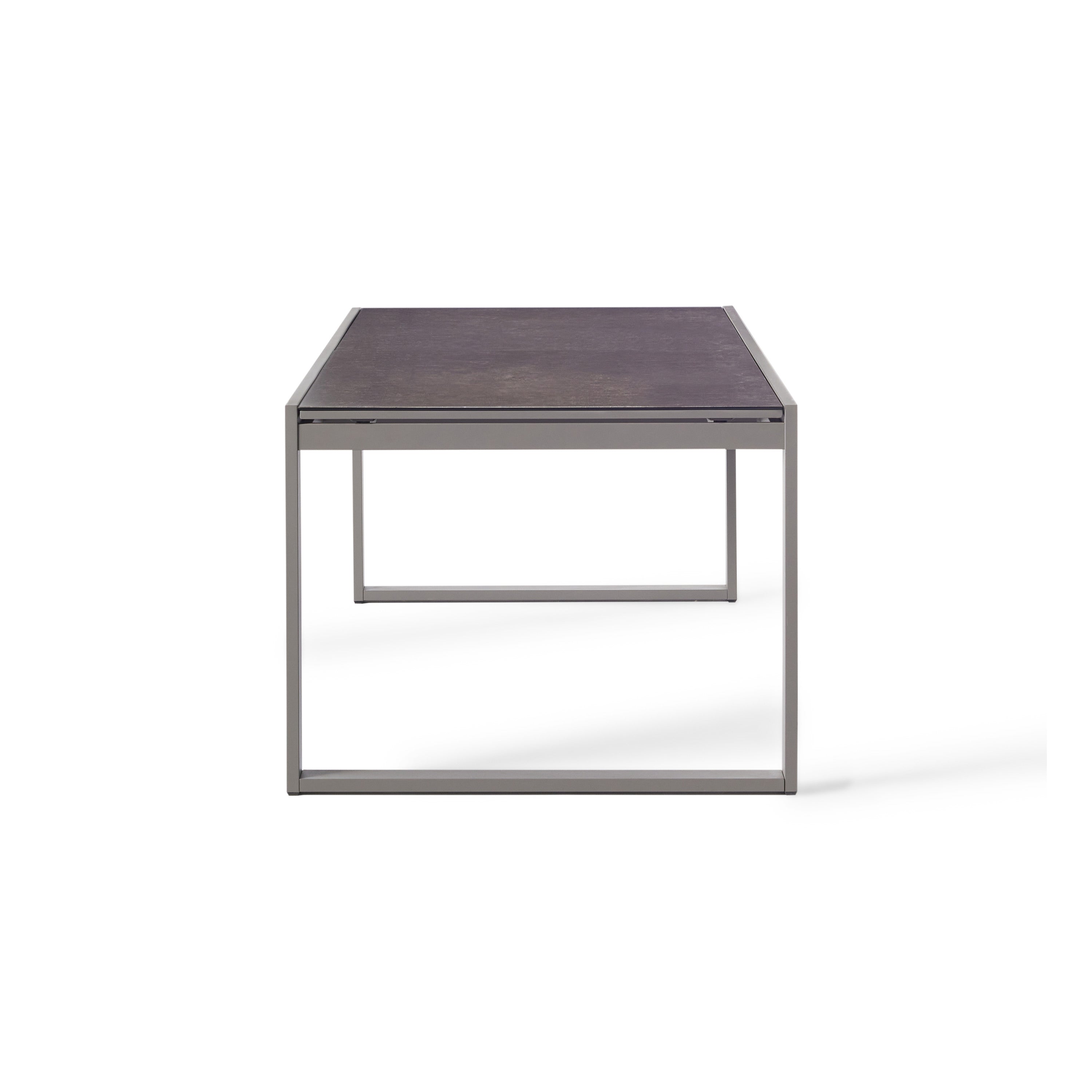 Diablo 87"-130" Extension Dining Table in Quartz Grey by Terra Outdoor Living is an extension dining table, with sled-style powdercoated aluminum frame and 'ceramic' coated tempered safety glass as the table top. It has a sleek modern look and can extend to suit the moment. Image shows table un-extended.