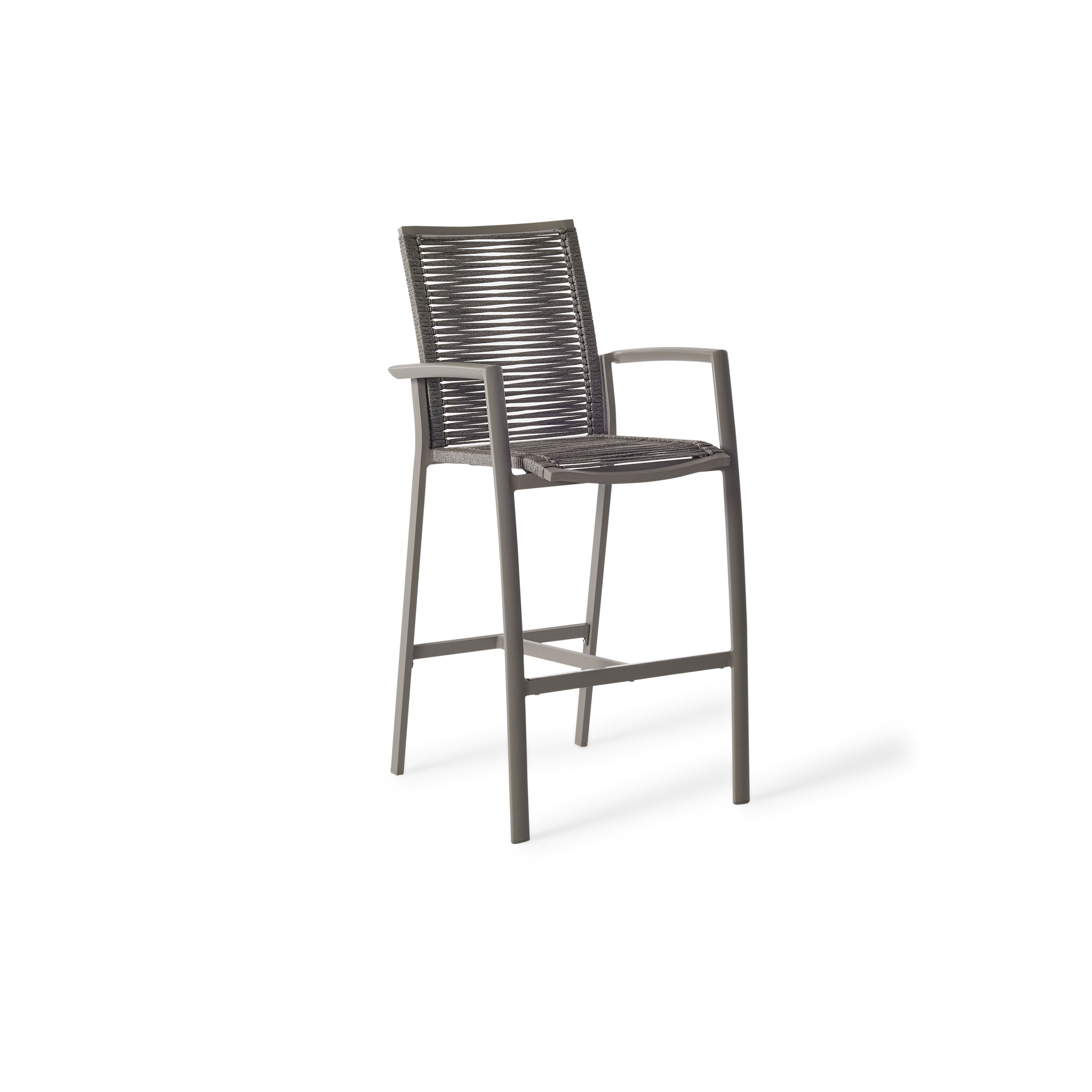 The Diablo Bar Chair in Quartz Grey by Terra Outdoor Living features squared off clean lines and rope wrapping for the seat and back. It has straight arms, a foot rest, and a cross bar for structural strength. Seat and back are subtly scooped for ergonomics.