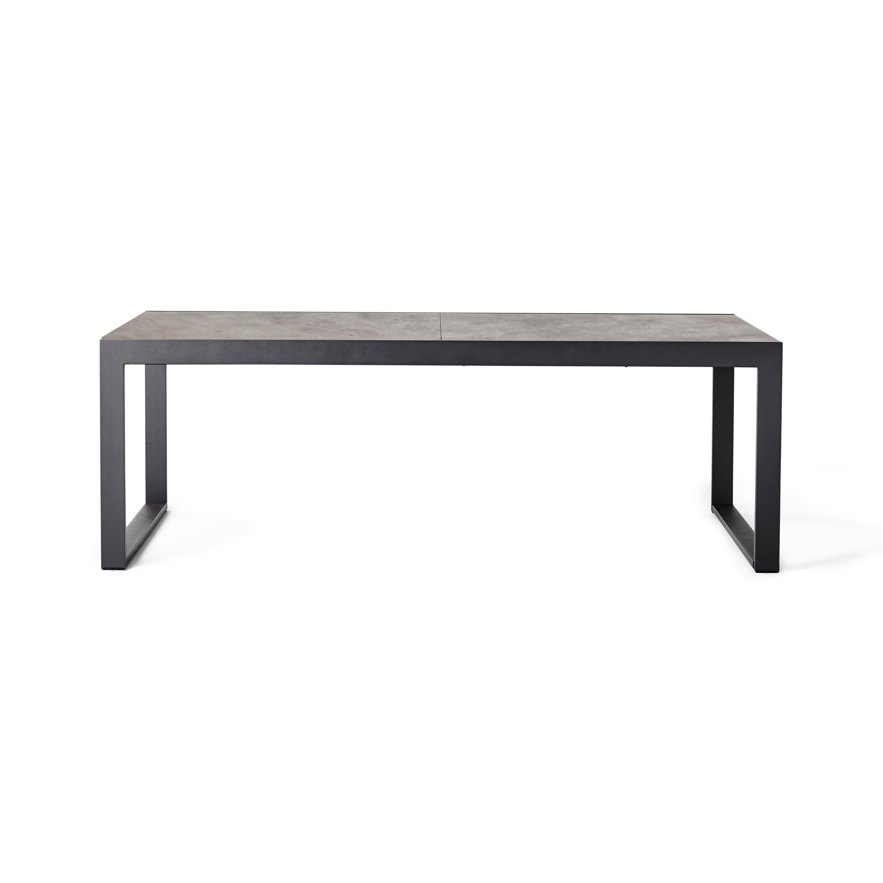 Diablo 87"-130" Extension Dining Table in Charcoal by Terra Outdoor Living is an extension dining table, with sled-style powdercoated aluminum frame and 'ceramic' coated tempered safety glass as the table top. It has a sleek modern look and can extend to suit the moment. Image shows table un-extended.