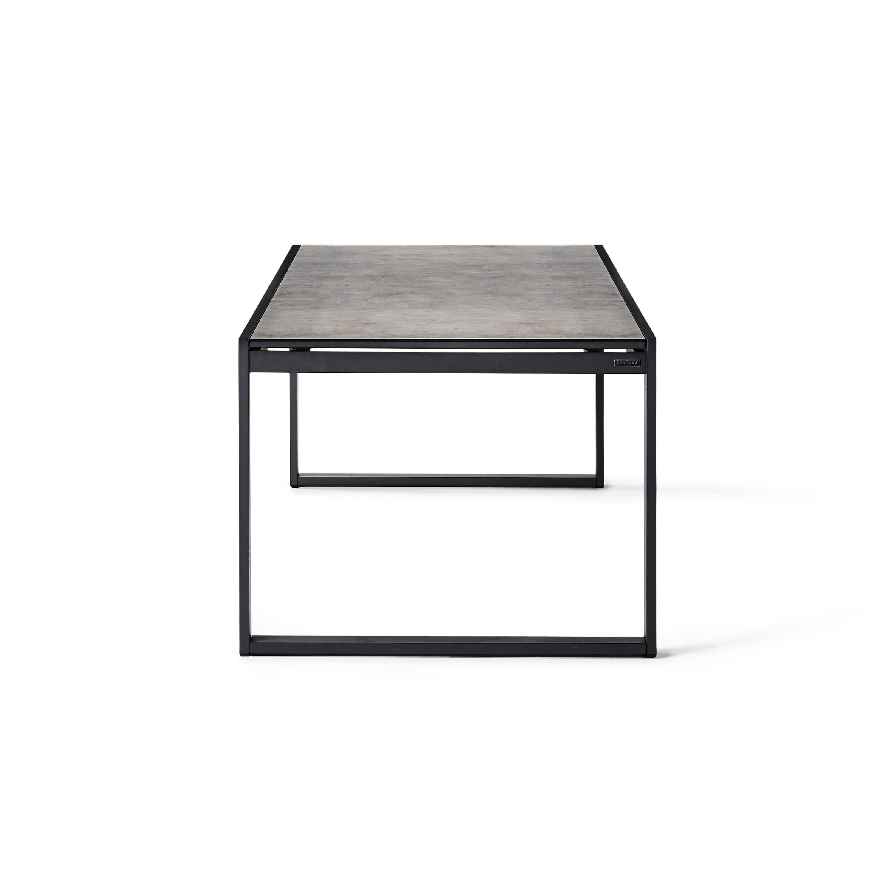 Diablo 87"-130" Extension Dining Table in Charcoal by Terra Outdoor Living is an extension dining table, with sled-style powdercoated aluminum frame and 'ceramic' coated tempered safety glass as the table top. It has a sleek modern look and can extend to suit the moment. Image shows table un-extended.