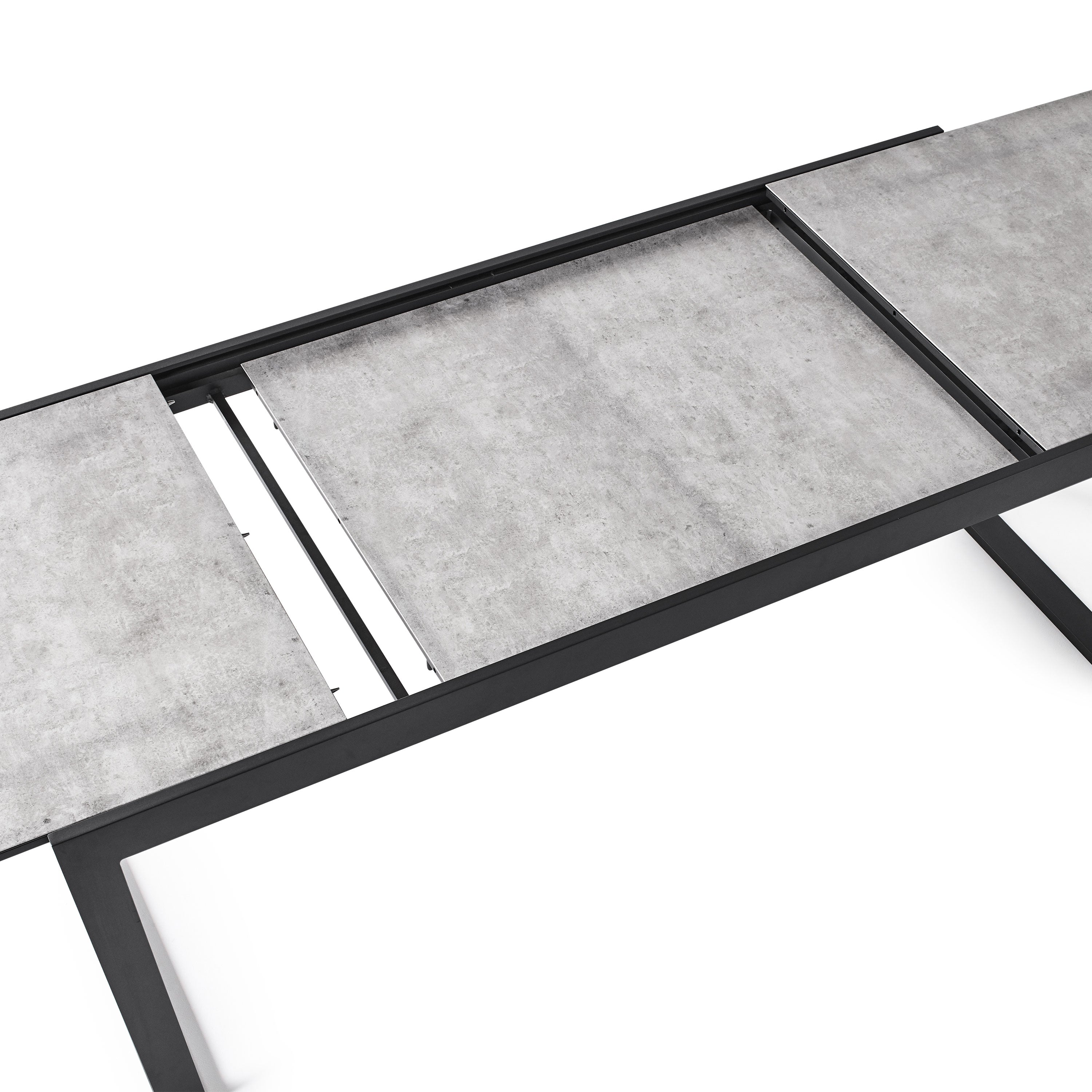 Diablo 87"-130" Extension Dining Table in Charcoal by Terra Outdoor Living is an extension dining table, with sled-style powdercoated aluminum frame and 'ceramic' coated tempered safety glass as the table top. It has a sleek modern look and can extend to suit the moment. Image shows table mid-extension, with leaves opened out and extension leaf still in its lowered state.