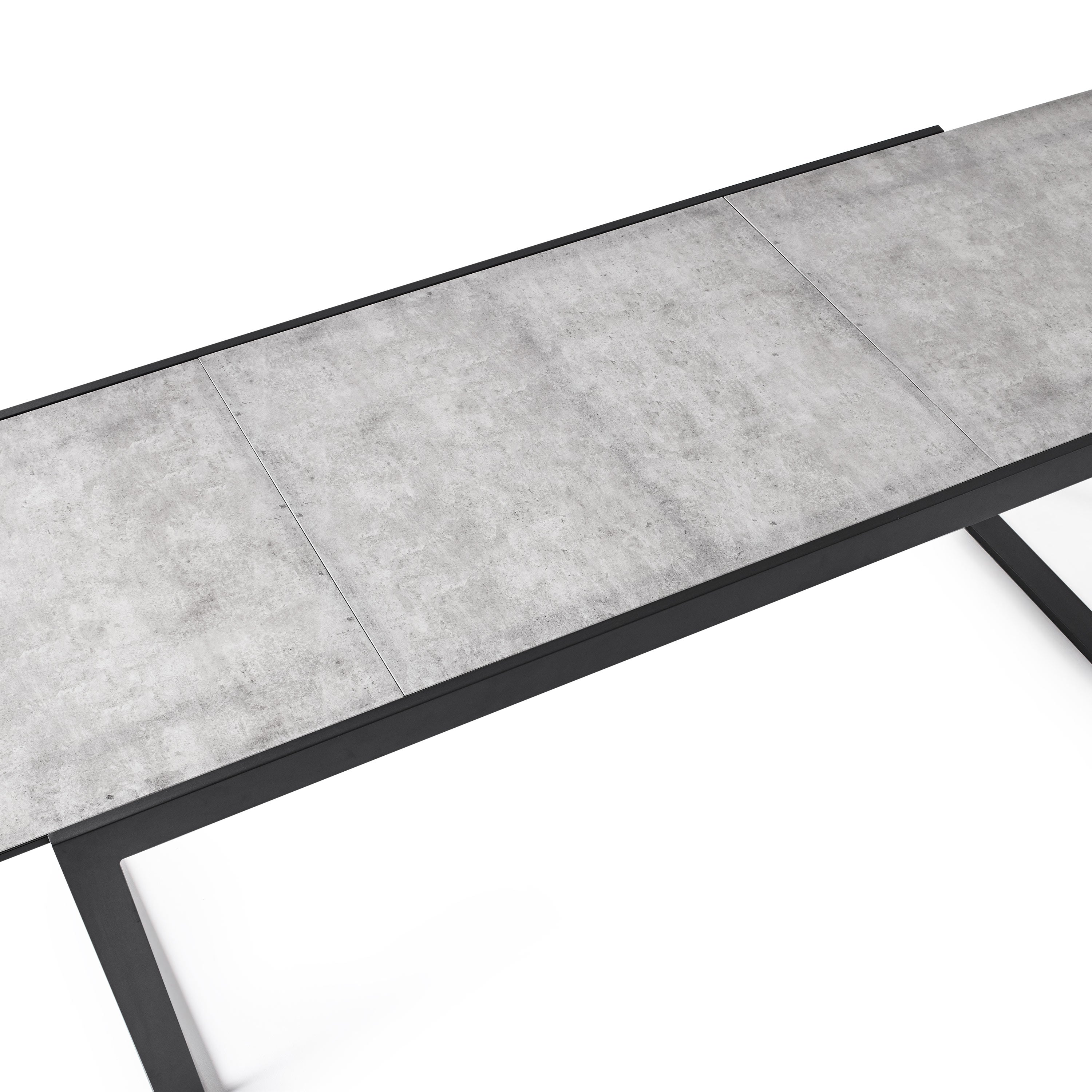Diablo 87"-130" Extension Dining Table in Charcoal by Terra Outdoor Living is an extension dining table, with sled-style powdercoated aluminum frame and 'ceramic' coated tempered safety glass as the table top. It has a sleek modern look and can extend to suit the moment. Image shows top-down view of the table after extension is complete.