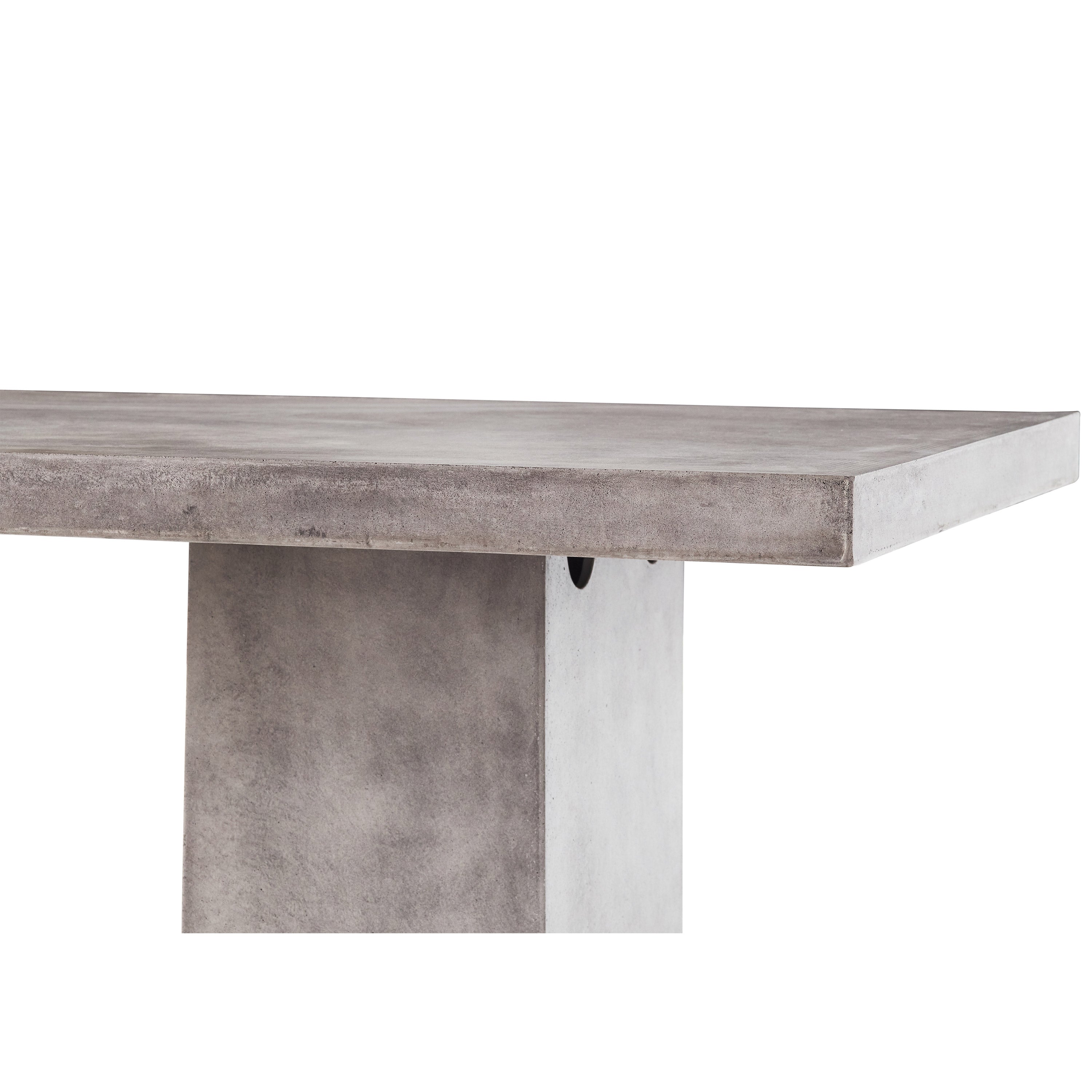 Mason 95" Dining Table by Terra Outdoor Living is made entirely of Glass Fiber Reinforced Concrete (GFRC), which resembles the look and feel of concrete but at a fraction of the weight and with increased strength. It features two cuboid bases as legs, with a slab of thick-edged GFRC as the top.
