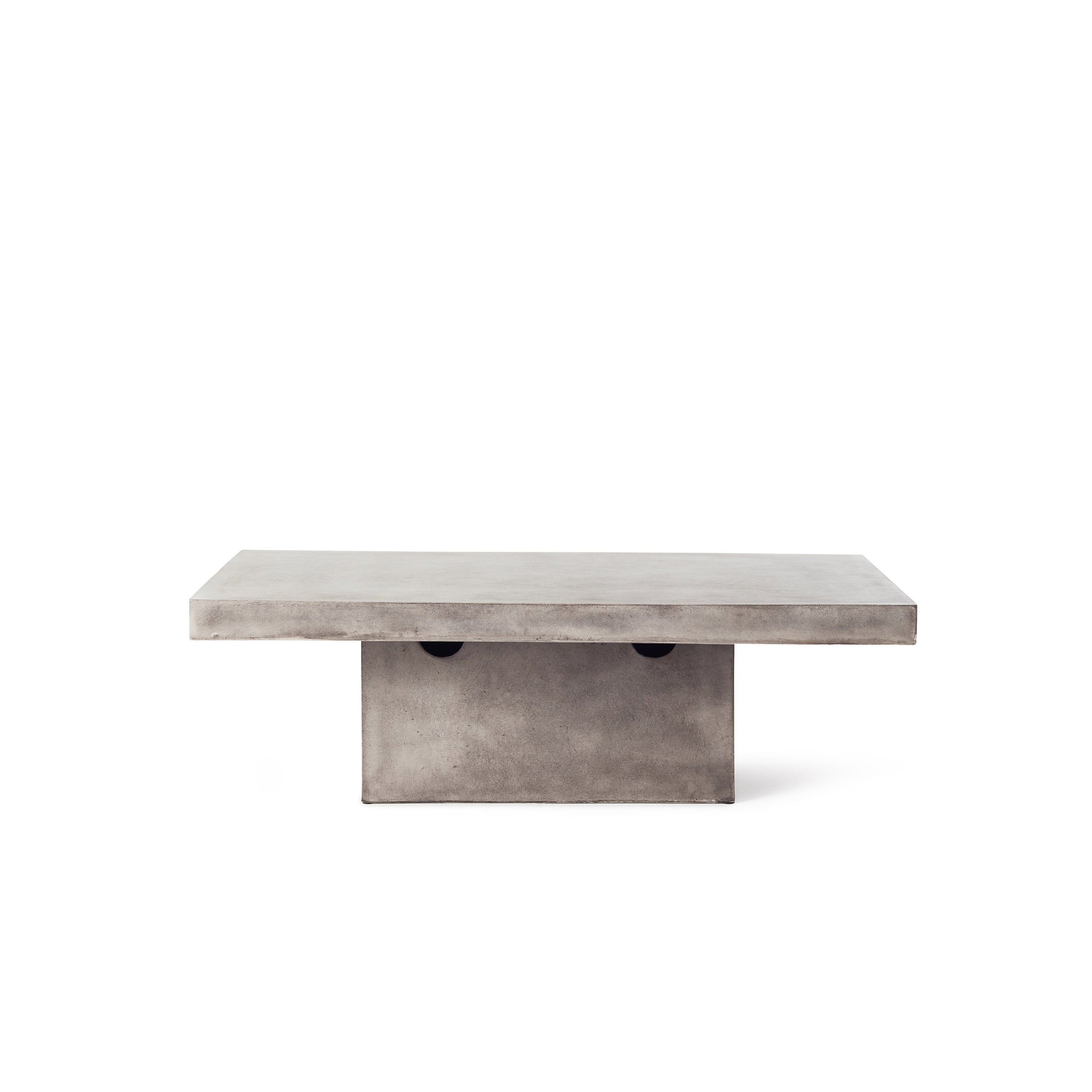 Mason Floating Rectangular Coffee Table by Terra Outdoor Living is made entirely from Glass Fiber Reinforced Concrete, and the surface effect resembles that of industrial concrete. It features a cuboid pedestal base, and a thick-edged slab of GFRC as the top.
