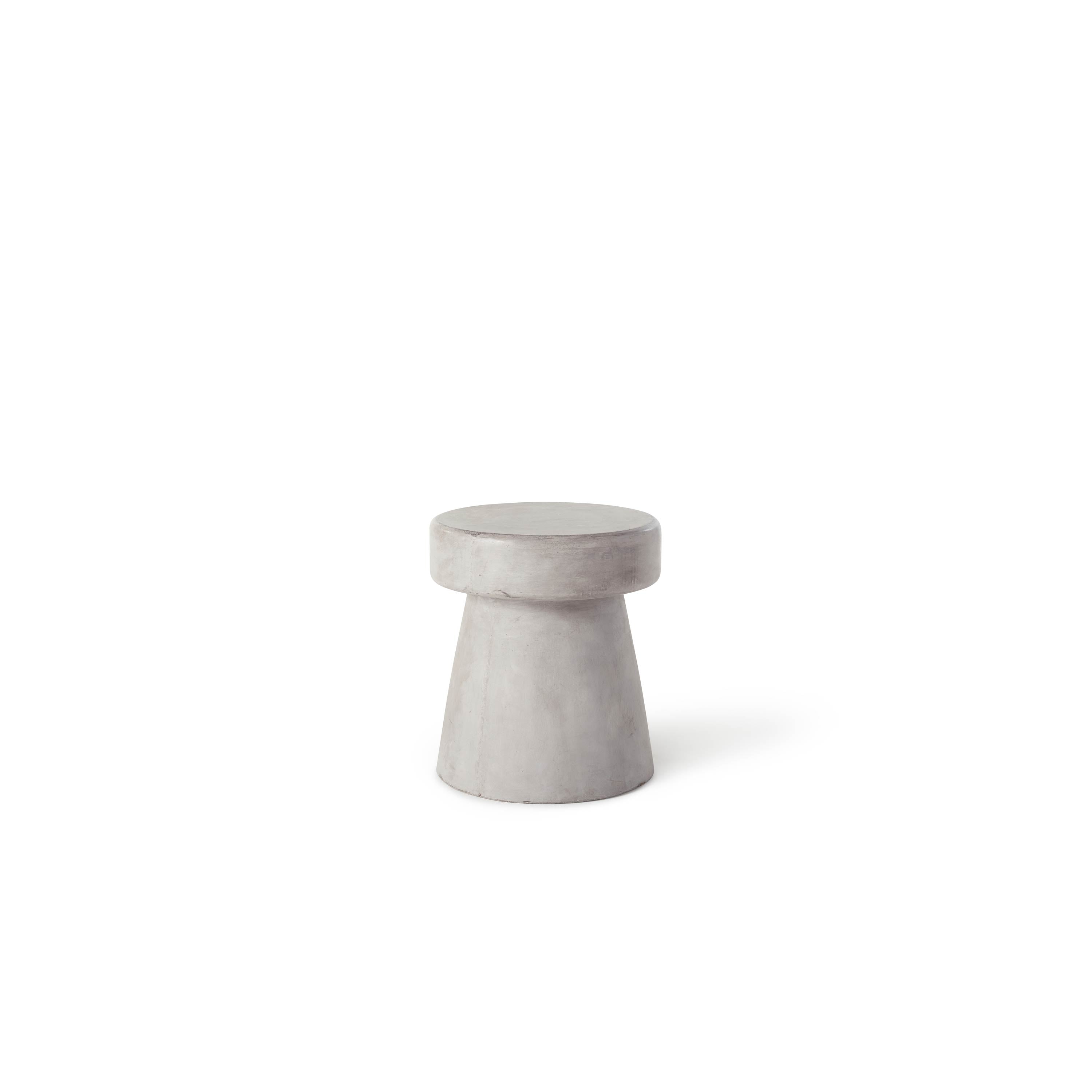 Mason Mushroom Side Table & Stool by Terra Outdoor Living is made entirely from Glass Fiber Reinforced Concrete (GFRC). It resembles the shape of a mushroom, and has a flat top. The base is flared out for an organic look.