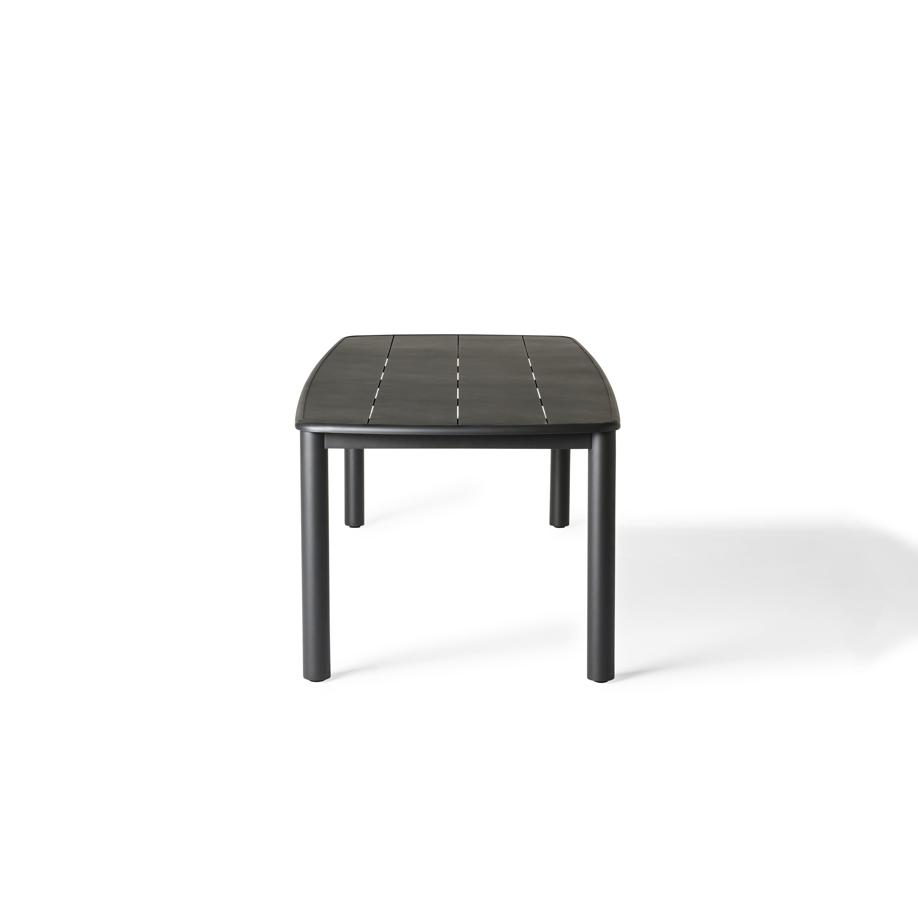 Stinson Dining Table in Aluminum by Terra Outdoor Living — crafted with a powdercoated aluminum frame in a charcoal finish, featuring a spacious slatted top that allows water to drain; comfortably seats up to 8 people, ideal for pairing with Stinson Dining Chairs or any of our dining chairs.