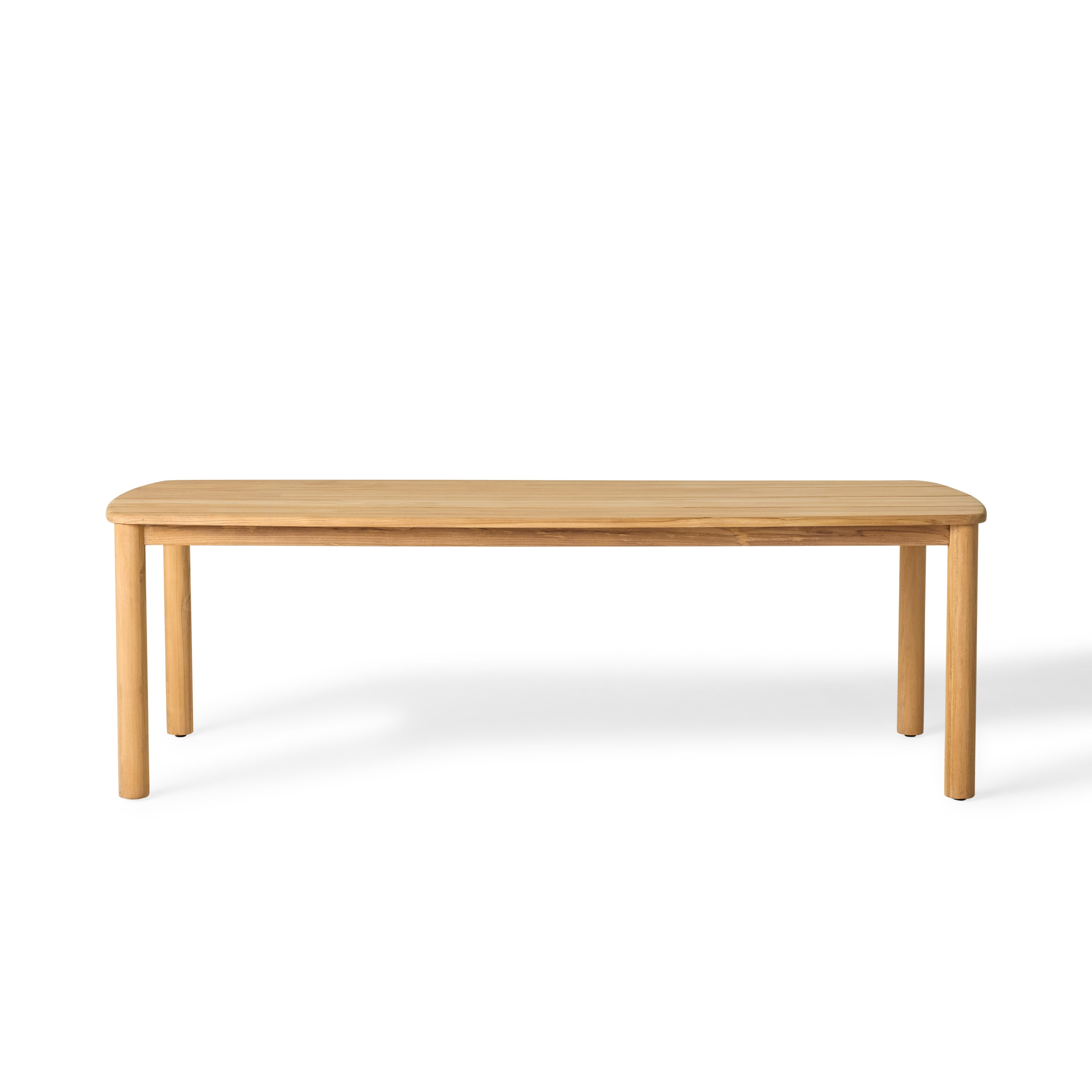 Stinson Dining Table crafted from premium teak in a natural finish, featuring curved edges and a spacious slatted tabletop seats up to 8 comfortably and allows water to drain, ideal for outdoor dining.