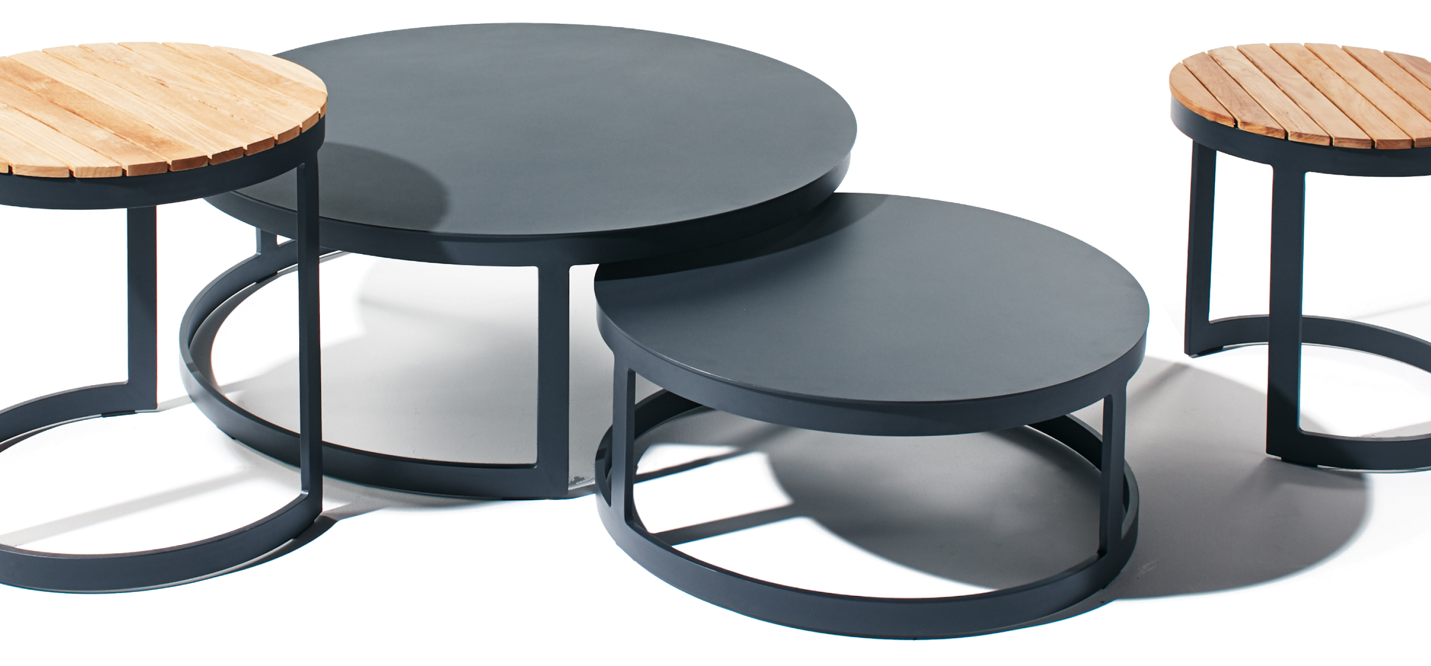 Ventana side and coffee tables made from aluminum and teak sold by Terra Outdoor
