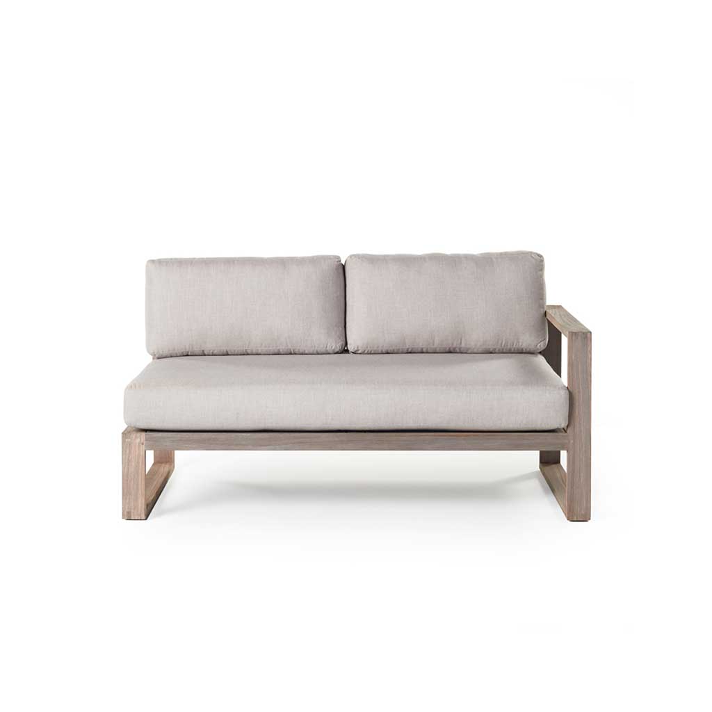 Belvedere Sectional Left Arm Loveseat by Terra Outdoor Living, featuring a low-profile, modern weathered teak frame with thick cushions, architectural lines, and airy proportions for relaxed outdoor living. Single arm rest is on left-hand side as seated, other side is open for sectional configuration.