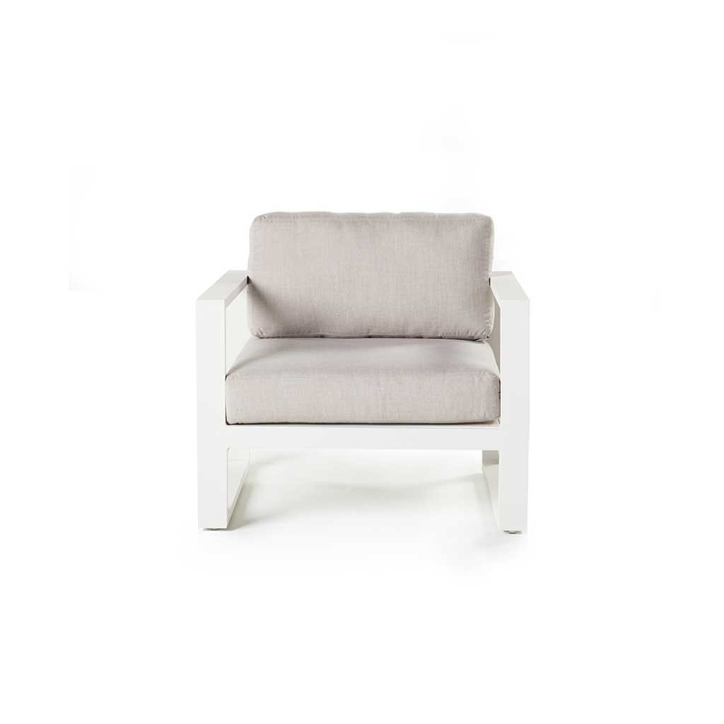 Belvedere Lounge Chair in White by Terra Outdoor Living features architectural lines, airy proportions, and deep weather-friendly cushions on a low-profile, durably finished aluminum frame with slatted detailing for drainage—designed for relaxed outdoor living. Features squared-off arms wide enough to rest a drink on.