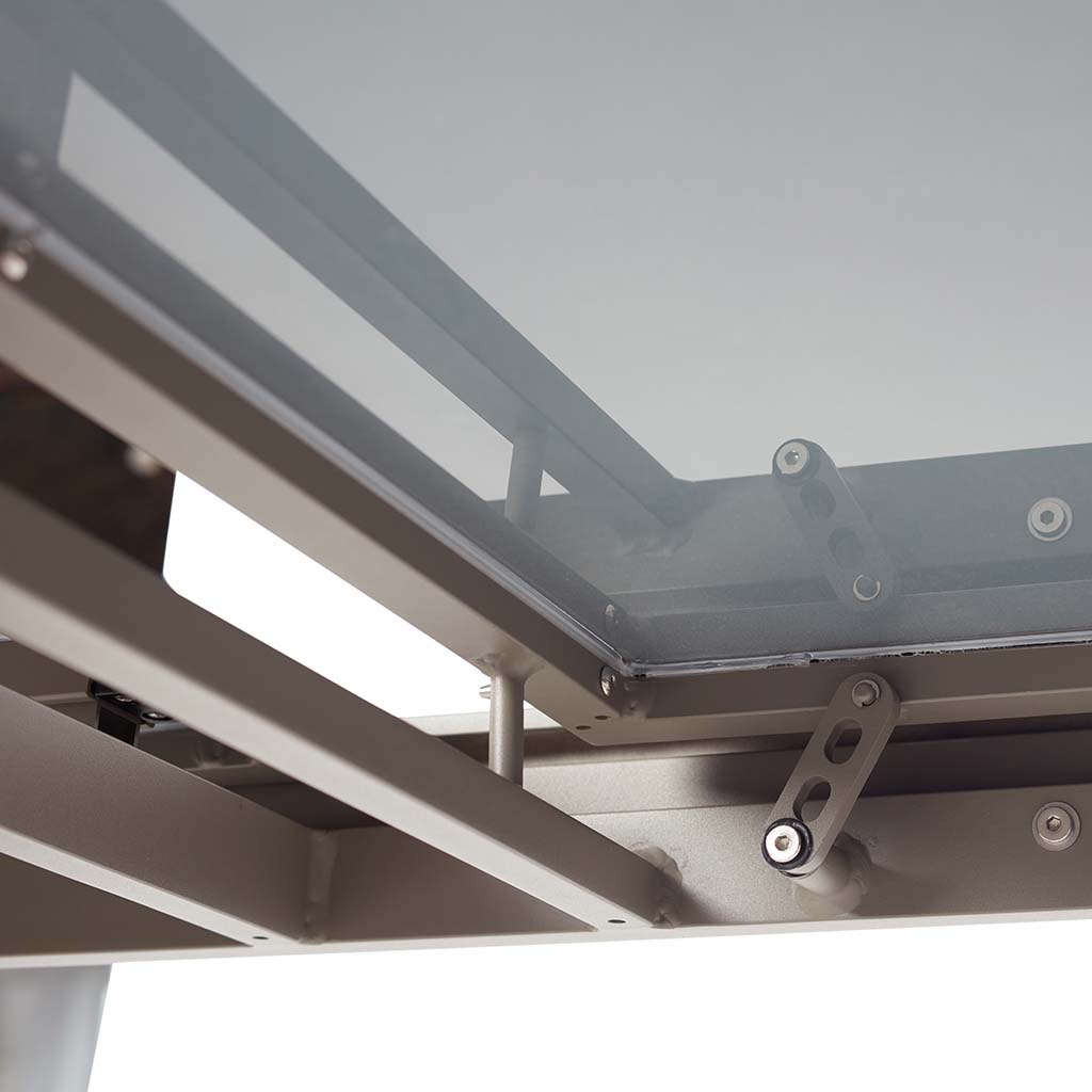Diablo 60"-90" Extension Dining Table in Charcoal by Terra Outdoor Living is an extension dining table, with sled-style powdercoated aluminum frame and 'ceramic' coated tempered safety glass as the table top. It has a sleek modern look and can extend to suit the moment. Image shows close up of extension mechanism from underneath.