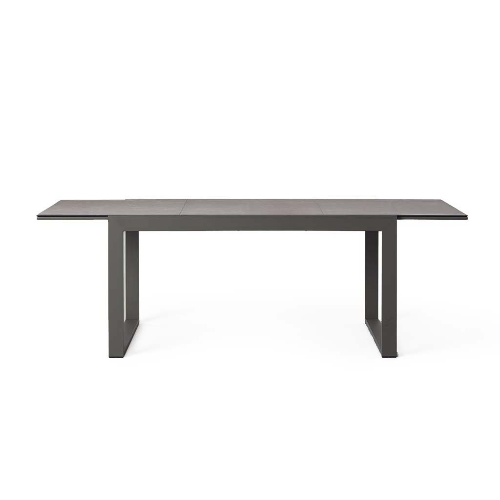 Diablo 60"-90" Extension Dining Table in Charcoal by Terra Outdoor Living is an extension dining table, with sled-style powdercoated aluminum frame and 'ceramic' coated tempered safety glass as the table top. It has a sleek modern look and can extend to suit the moment.