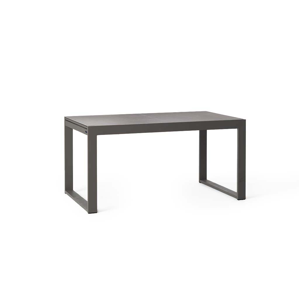 Diablo 60"-90" Extension Dining Table in Charcoal by Terra Outdoor Living is an extension dining table, with sled-style powdercoated aluminum frame and 'ceramic' coated tempered safety glass as the table top. It has a sleek modern look and can extend to suit the moment. Image shows table in its un-extended state.