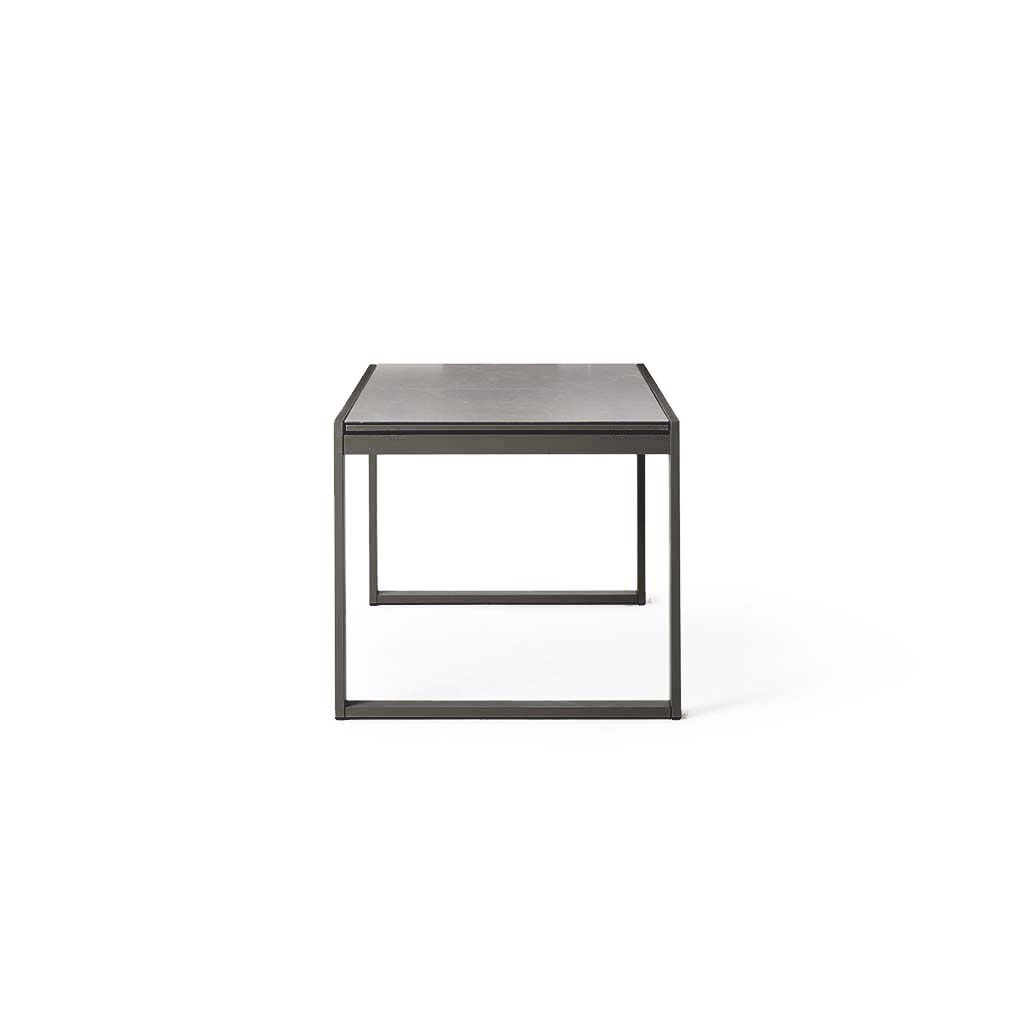 Diablo 60"-90" Extension Dining Table in Charcoal by Terra Outdoor Living is an extension dining table, with sled-style powdercoated aluminum frame and 'ceramic' coated tempered safety glass as the table top. It has a sleek modern look and can extend to suit the moment. Image shows table in its un-extended state.