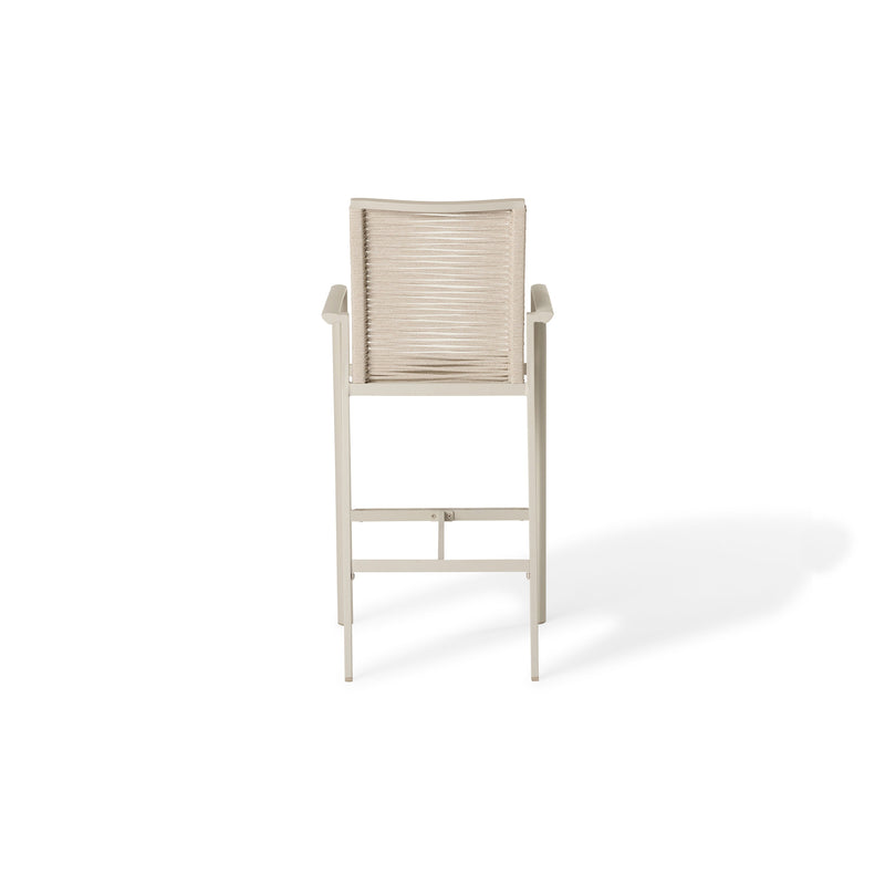 The Diablo Bar Chair in Dune by Terra Outdoor Living features squared off clean lines and rope wrapping for the seat and back. It has straight arms, a foot rest, and a cross bar for structural strength. Seat and back are subtly scooped for ergonomics.
