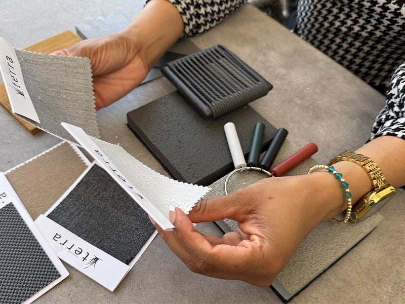 Woman reviewing outdoor furniture swatches and color samples at desk