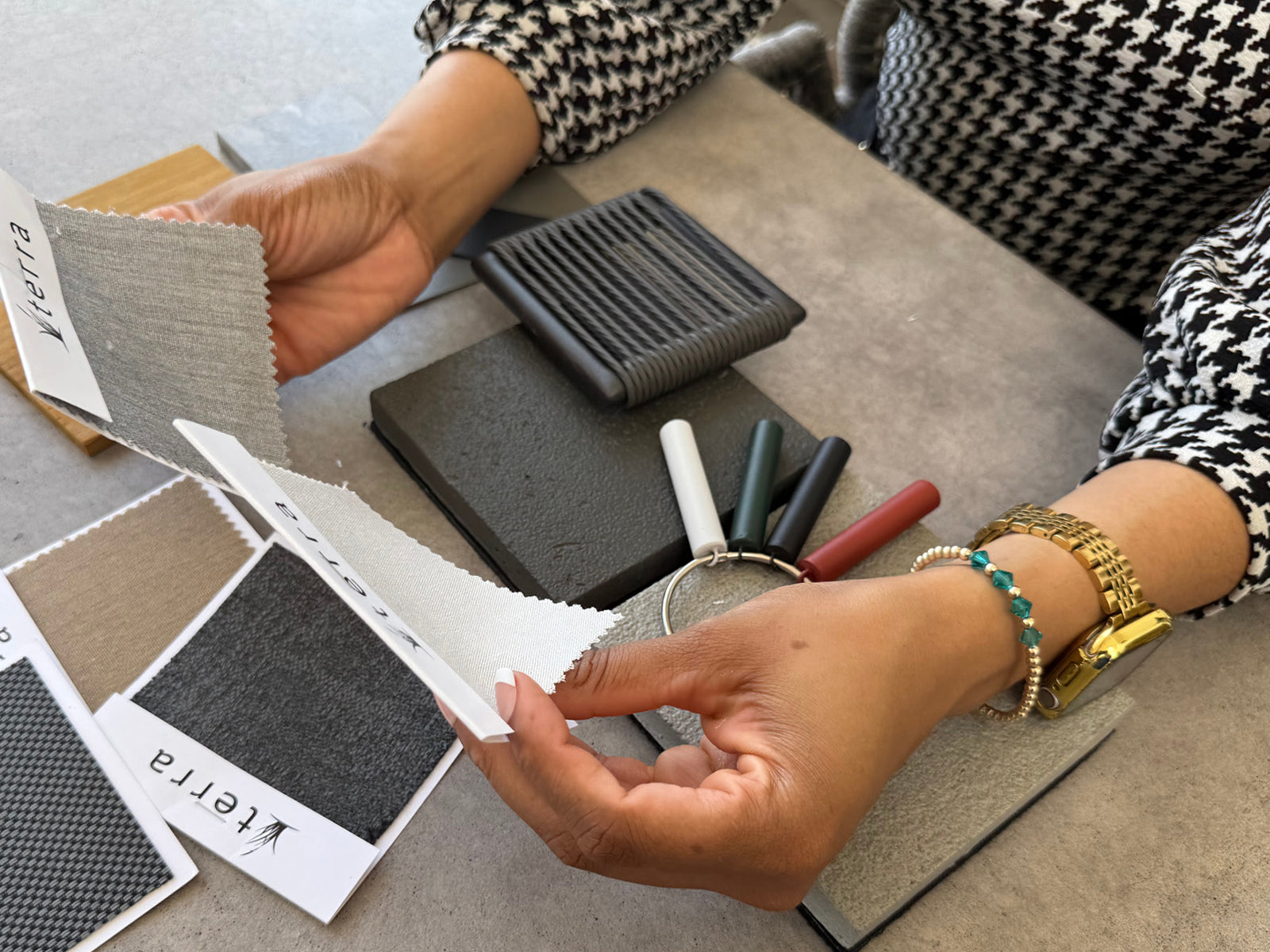 Woman reviewing outdoor furniture swatches and color samples at desk