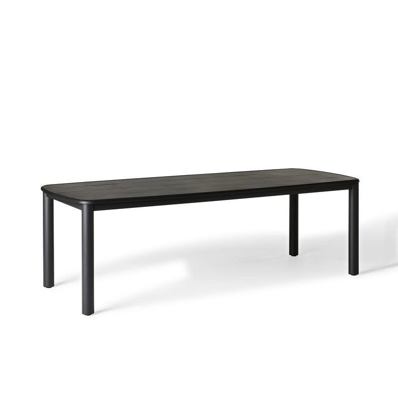 Stinson Dining Table in Aluminum by Terra Outdoor Living — crafted with a powdercoated aluminum frame in a charcoal finish, featuring a spacious slatted top that allows water to drain; comfortably seats up to 8 people, ideal for pairing with Stinson Dining Chairs or any of our dining chairs.