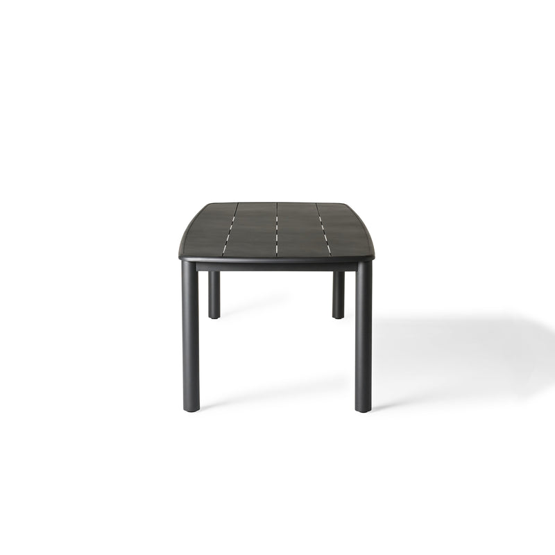 Stinson Dining Table in Aluminum by Terra Outdoor Living — crafted with a powdercoated aluminum frame in a charcoal finish, featuring a spacious slatted top that allows water to drain; comfortably seats up to 8 people, ideal for pairing with Stinson Dining Chairs or any of our dining chairs.